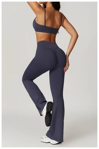 Detail of cross-back sports bra and flare yoga leggings in slate blue recycled fabric