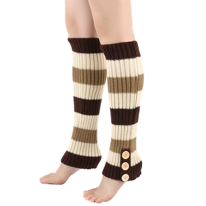 Close-up of striped knit leg warmers with decorative wood buttons and ribbed texture