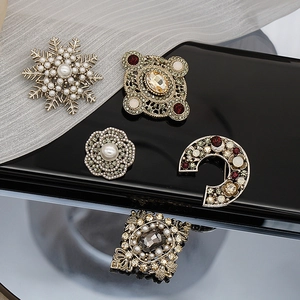 Vintage baroque brooch set with pearls and rhinestones on elegant dark background