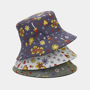 Detailed stack of floral bucket hats in purple, beige and olive green cotton
