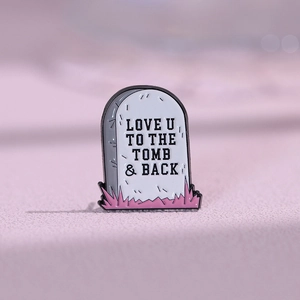 Skull tombstone enamel pin with Love You to the Tomb and Back text on pink background
