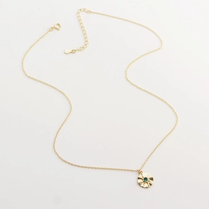 Detail of s925 silver star necklace with green emerald stone and radiant textured pendant