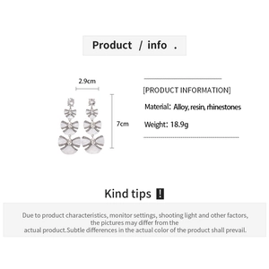 Detail view showing dimensions of layered resin bow earrings with rhinestone accents