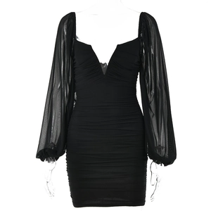 Detail of sheer lantern sleeves and ruching on a black V-neck bodycon mini dress