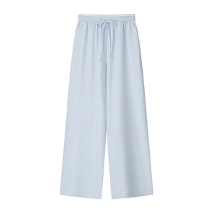 Detail of light blue wide-leg trousers showing elastic drawstring waist and ribbed texture
