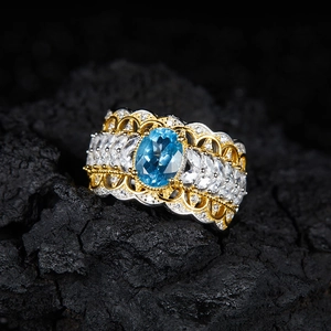 Vintage S925 silver ring with blue topaz and marquise gems on black rock texture