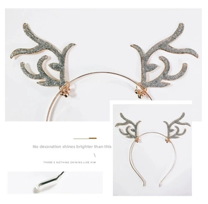 Detail of rose gold metal reindeer headband with silver sequins and small festive bells