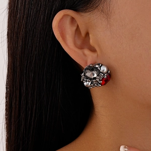 Detailed view of vintage cluster earrings with grey crystals and red square stones