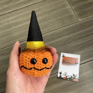 Detail of handmade crochet Halloween pumpkin doll with hat and motivational support card