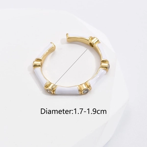 Detail of gold plated ring with white enamel, zircon stones and adjustable diameter