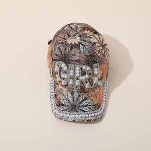 Floral baseball cap with GIRL pearl and rhinestone crystal embellishments on neutral background