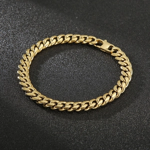 Detail of a heavy gold-plated Cuban link bracelet for men with a secure rectangular clasp