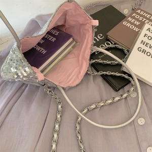 Top view of silver sequin shoulder bag with pink lining and metal chain strap