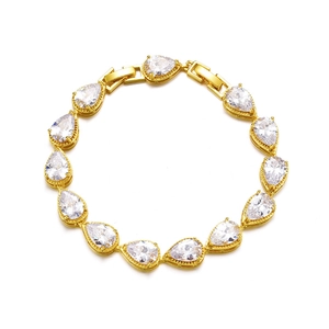 Detailed macro view of 14 pear-cut AAA cubic zirconia stones on a gold bridal bracelet