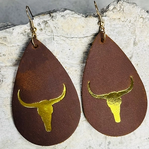 Brown teardrop leather earrings featuring a golden bull head skull pattern on stone