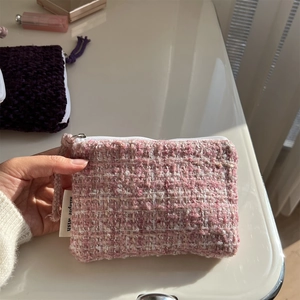 Close-up of pink and white tweed mini pouch for coins and lipstick with zipper