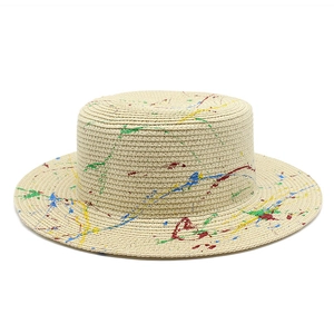 Graffiti boater straw hat with colorful paint splatter design and flat top style
