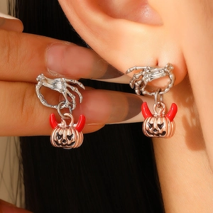 Ghost hand and pumpkin stud earrings with silver skull claw and rose gold pumpkin detail