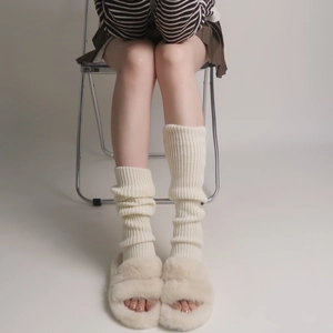 Chic cream white knitted leg warmers for women in a cozy winter style and long design
