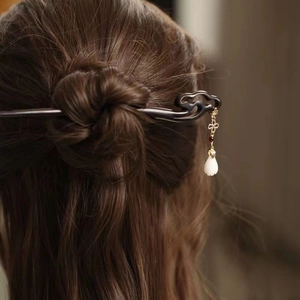 Minimalist wooden hair stick with elegant Ruyi cloud pattern and flowing golden tassel