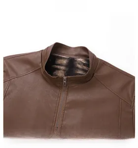 Detail of brown faux leather jacket featuring stand collar and metal zipper with fleece lining