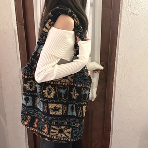 Detailed view of plush tote bag with ethnic patterns and large capacity on model shoulder