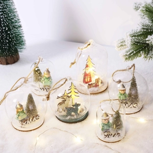 LED lit Christmas glass globes with reindeer and Santa miniatures on fake snow
