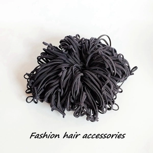 Detail of high-elastic black hair ties showing thick nylon texture and durable rubber core