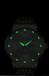 Close-up of luminous green hands and double calendar display on men's quartz watch