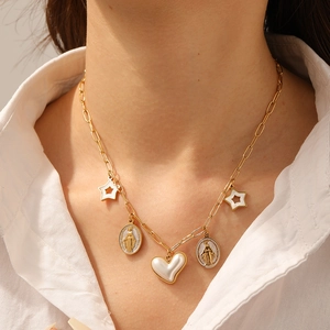 Golden cross chain necklace featuring pearl hearts, stars, and oval virgin mary pendants