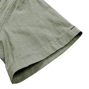 Detail of grass green cotton linen shirt sleeve with reinforced double stitching