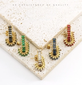 Macro shot of 18K gold plated U-shaped earrings with baguette-cut zircon in five colors