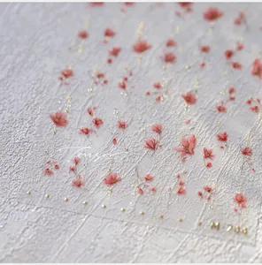 Detail shot of self-adhesive nail stickers M-744 with red flowers and gold glitter dots