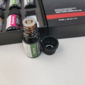 Close-up of a 10ml essential oil glass bottle with a premium white gift box set