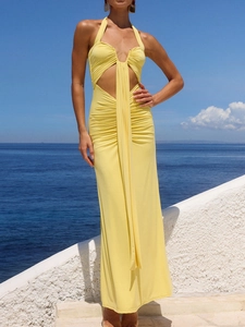 Detail of yellow halter neck dress with sexy ruched cut-out design and flowy fabric