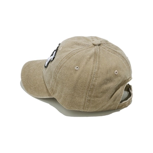 Detail view of khaki corduroy baseball cap with adjustable metal buckle strap