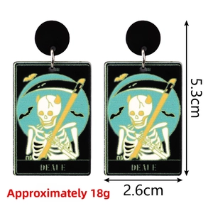 Close-up of tarot Death card acrylic earrings with skull and bat gothic pattern