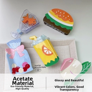 Set of five creative acetate hair claws in burger, goldfish, and fruit shapes