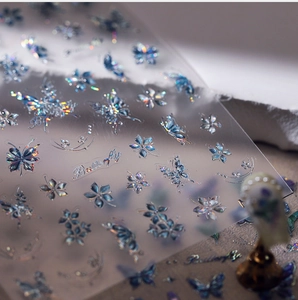 Macro shot of 3D laser iridescent butterfly nail stickers with metallic holographic finish