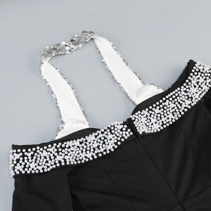 Detail of off-shoulder neckline with pearl beads and shimmering sequin halter straps