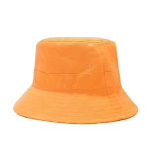 Close-up of bright orange cotton bucket hat showing fabric texture and eyelet detail