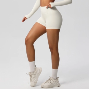 Detail of high waist fitness shorts and long sleeve top in cream white ribbed fabric