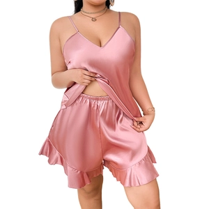 Dusty pink two-piece satin pajama set with V-neck camisole and ruffled hem shorts