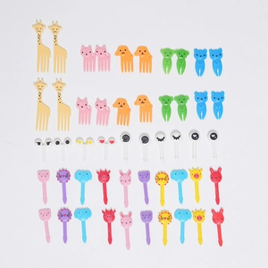 Close-up of assorted colorful plastic animal and eye shaped fruit picks for kids bento