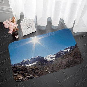 Detailed close-up of mountain landscape flannel floor mat on dark wood floor