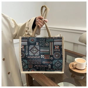 Detail of bohemian cotton linen tote with geometric patterns and woven handles