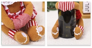 Detailed knit ginger-man bottle cover showing soft fleece texture and festive holiday scene