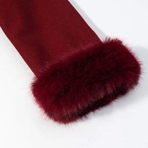 Detail of burgundy wool coat sleeve featuring luxurious faux fur trim on cuff