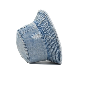 Frayed edge light blue denim bucket hat with distressed holes and retro street style