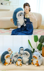 Multiple sizes of cat plush toys in shark outfits shown in various colors on a sofa